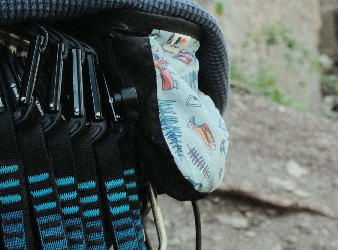 An Oso Beta Chalk Bag attached to a climber's harness showcasing the drawstring closure